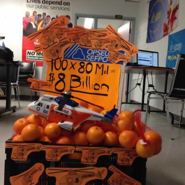 Display of oranges that says: 100x80 Million equals $8 billion