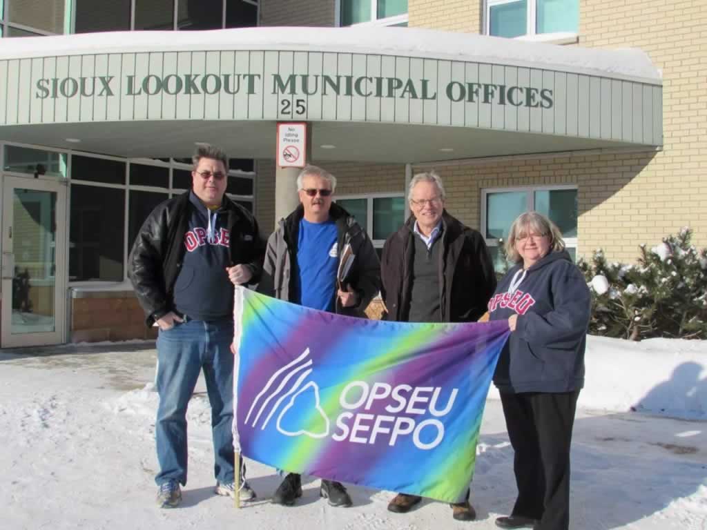OPSEU members holding up OPSEU flag outside of Sioux lookout municipal offices