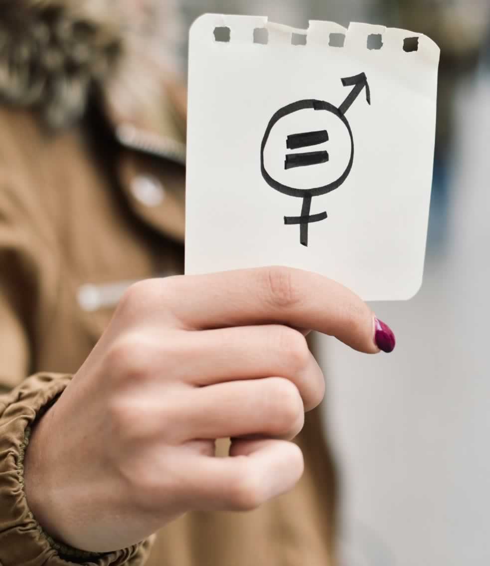 A hand holding up a pay equity symbol drawn on a piece of paper