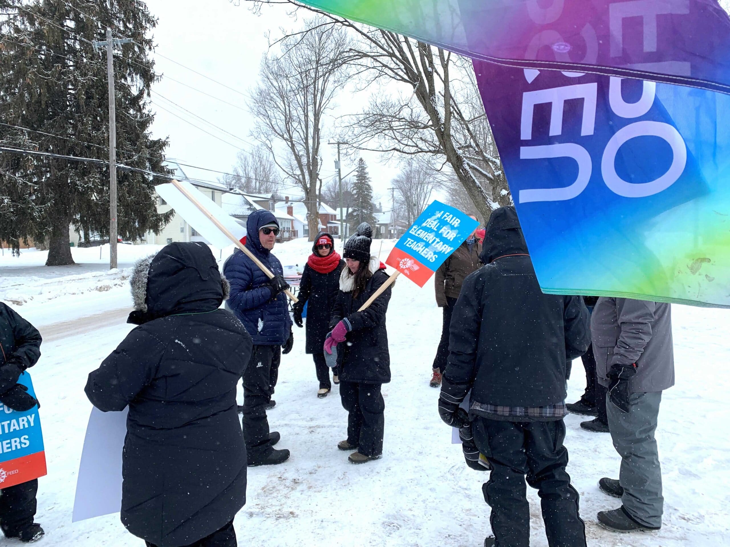 OPSEU members standing outside of school to protest