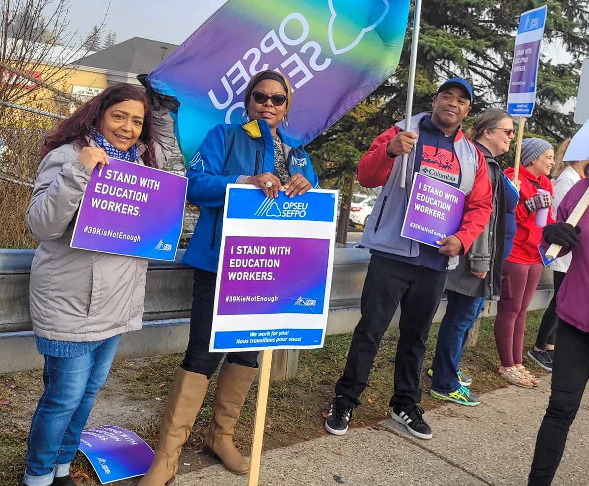 Workers with OPSEU/SEFPO flag supporting education workers at the office of Charmaine Williams in Brampton.