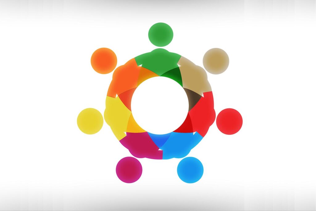 Seven simple figures of different colours arranged in a circle as though around a table
