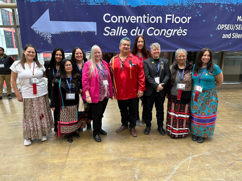 Stacey Laforme, Chief of Mississaugas of the Credit First Nation (red shirt) is joined by OPSEU/SEFPO President JP Hornick and FVPT Laurie Nancekivell before the opening of Convention 2023.