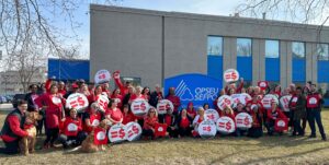 Group of people holding up equal pay signs